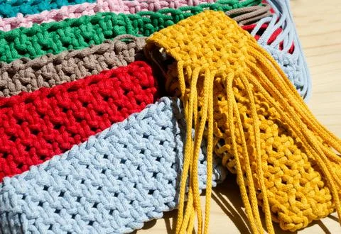 Small handbags knitted with macrame technique. Stock Photos