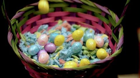 Small handful of easter eggs fall into basket in slow motion Stock Footage 87692145