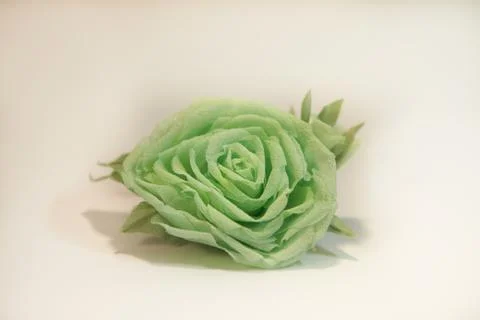 Small handmade brooch in the form of a green rose made of cloth Stock Photos