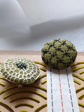 Small handmade brooches with visible thread texture. Foto stock