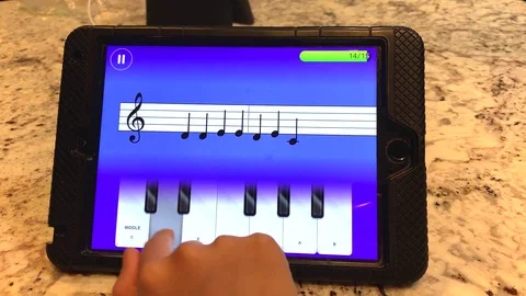 Small hands learning to play beginning notes on the piano using a virtual Video stock 107293061