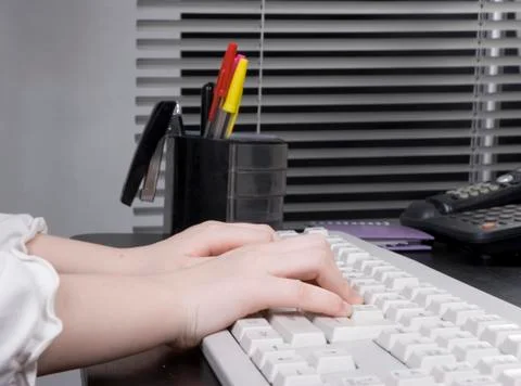 Small hands on pc keyboard Stock Photos