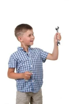 Small handsome builder in blue checkered shirt holding a wrench and a Stock Photos