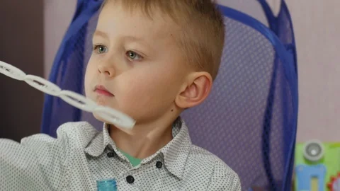 Small happy boy blowing bubbles at home. Video stock 128399222