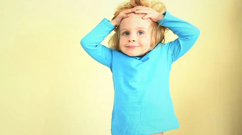 Small happy redhead girl posing against wall. Stock Footage 37014071