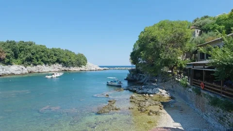 The small harbor at Damouhari in Pelion, Greece, featuring clear turquoise water Stock Footage 346677067