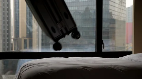 Small hard suitcase flying and fall on bed, slow motion shot Stock Footage 102660537