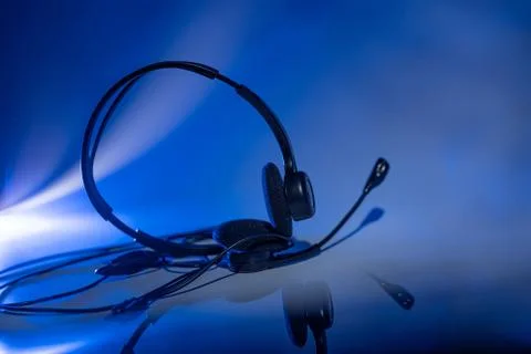 Small headset on a blue background Stock Photos