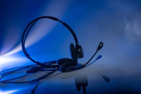Small headset on a blue background Stock Photos