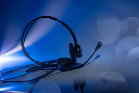 Small headset on a blue background Stock Photos