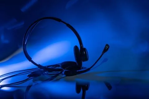 Small headset on a blue background Stock Photos