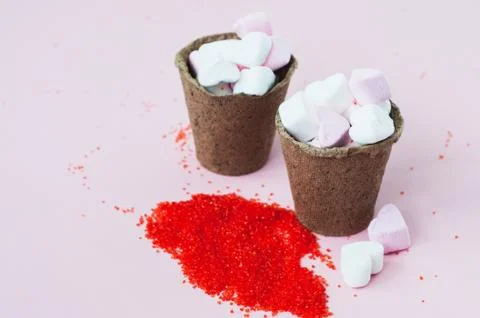 Small heart shaped marshmallows in a peat pots Stock Photos