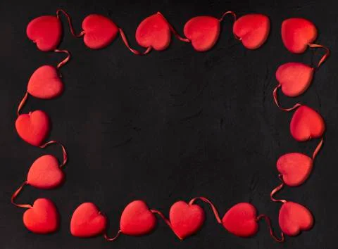 Small hearts forming a rectangle on a black background for Valentine's day Stock Photos