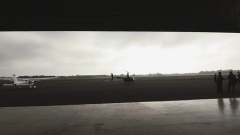 Small Helicopter prepare to take off outside a hangar Video stock 127428858