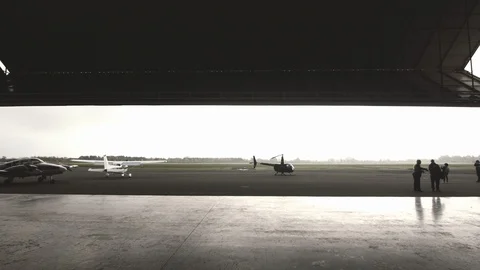 Small helicopter prepare to take off outside a hangar Video stock 127429390