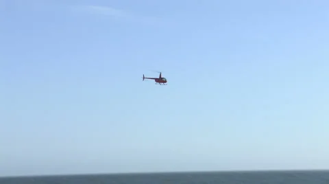 Small Hellicopter Flies over a Beach Stock Footage 4281936