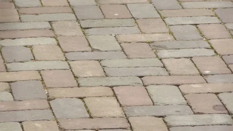 A small high-speed drone takes off from the sidewalk tile Stock Footage 81722723