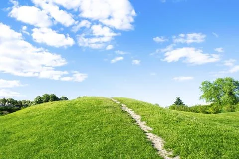 Small hiking trail, path climbing up the mountain, hill, mound with green g.. Stock Photos