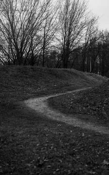 Small hills and a path between them. Black and white photo Stock Photos