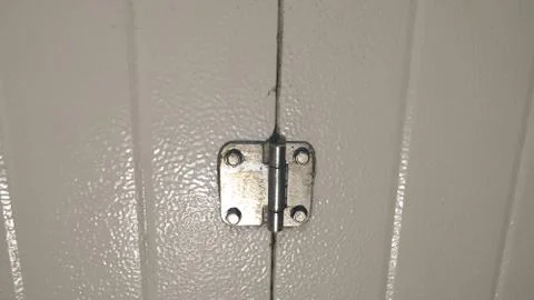 Small hinge on the metal gate, close-up. Background. Stock Photos