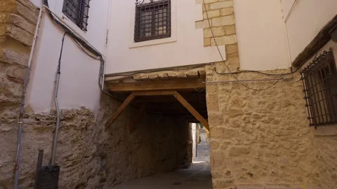 Small historic square with covered passage and stone buildings in the old Stock Footage 340970017