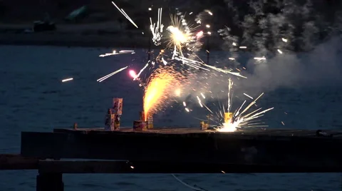 Small home-style firework on jetty in early evening Stock Footage 65470459