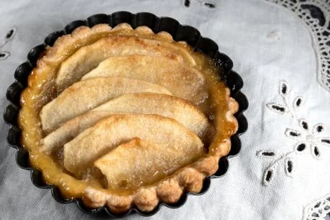 Small homemade apple pie on rustic background Stock Photos