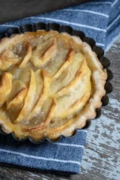 Small homemade apple pie on rustic background Stock Photos
