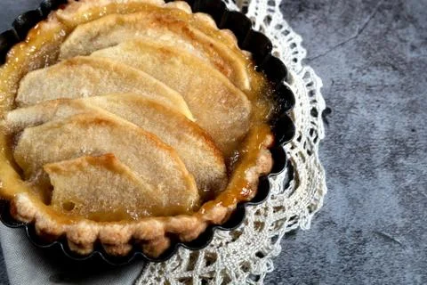 Small homemade apple pie on rustic background Stock Photos