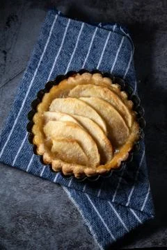 Small homemade apple pie on rustic background Stock Photos