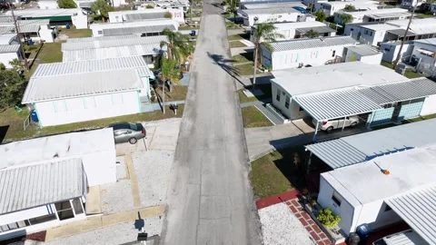 Small homes in suburb of town in Florida. Aerial tilt up shot. Sunny day in Video stock 306340576