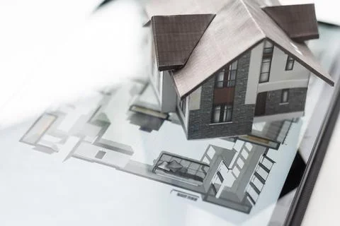 Small house model is on screen tablet and icons home electronics devices Fotos de archivo