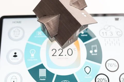 Small house model is on screen tablet and icons home electronics devices Fotos de archivo
