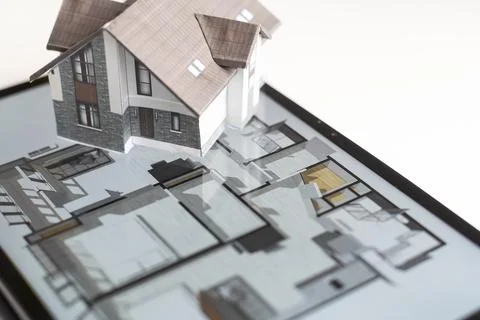 Small house model is on screen tablet and icons home electronics devices Fotos de archivo