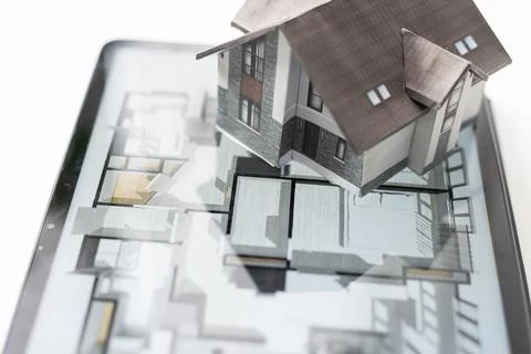 Small house model is on screen tablet and icons home electronics devices Fotos de archivo
