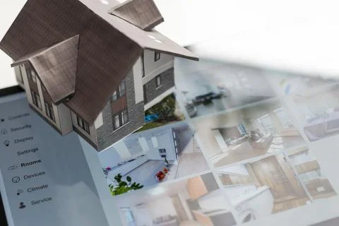 Small house model is on screen tablet and icons home electronics devices Fotos de archivo