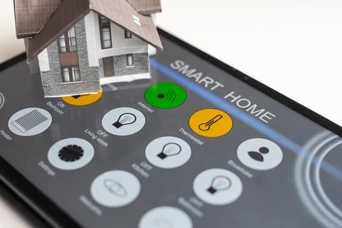 Small house model is on table and icons home electronics devices connecting with Fotos de archivo