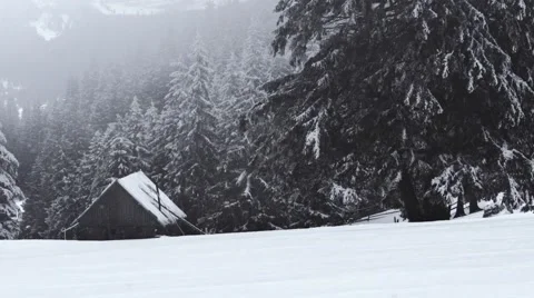 Small house on the mountain while snowing Stock Footage 58934181