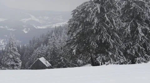 Small house on the mountain while snowing Stock Footage 61416447
