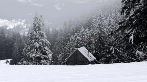 Small house on the mountain while snowing Stock Footage 61416461