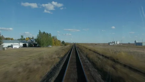 A Small House passes the speeding Passenger Train Stock Footage 92674582