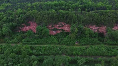 A small house by a red rock with a forest Stock Footage 154373646