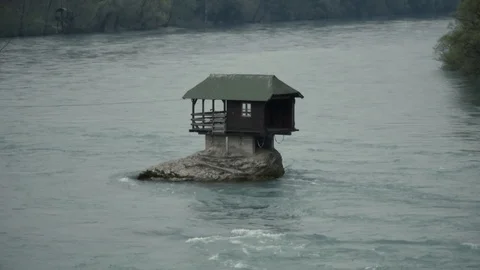 Small House in the River, standing on a Stone 스톡 동영상 91244748