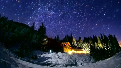 Small house in snow forest - Christmas stars light up smoothly and twinkling 4K Stock Footage 220328898