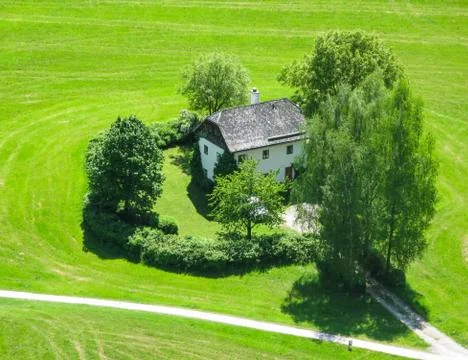 A small house surrounded by trees in the middle of a field near Vienna. Austr Stock Photos