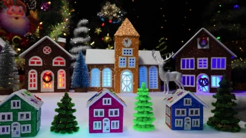 Small houses against the backdrop of a large Christmas town and a deer Stock Footage 291313280