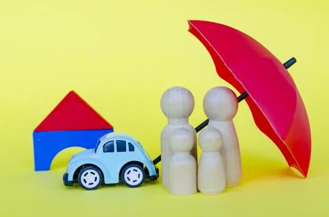 Small human figures with a red umbrella representing security and insurance.. Stock Photos