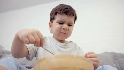 Small Hungry Boy Eating Tasting Sweet Corn Flakes With Milk Stock Footage 239067226