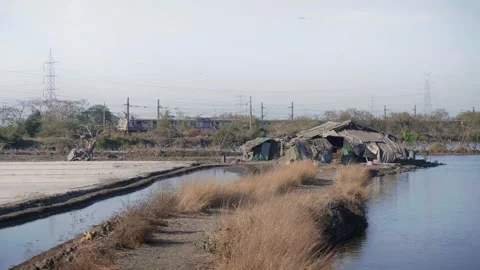 Small hut surrounded by the salt pan flats with local train running in the back 스톡 동영상 337092837