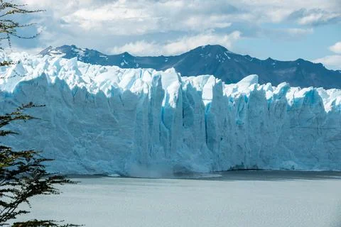 Small ice chunks from the edge of Perito Moreno Glacier are falling and calving Stock Photos